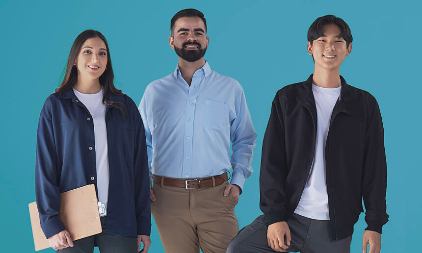 Three people wearing different Lazzar work uniforms posing against a turquoise blue background
